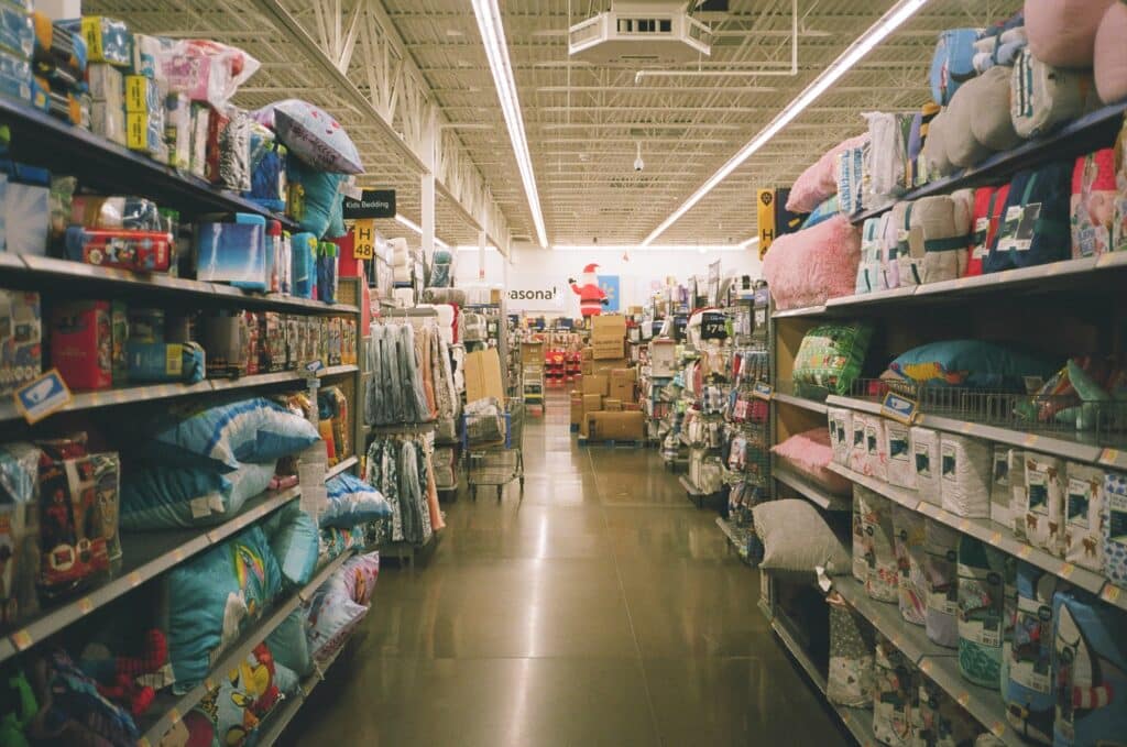 An isle of fully stocked shelves in Walmart, where no customers are in sight.