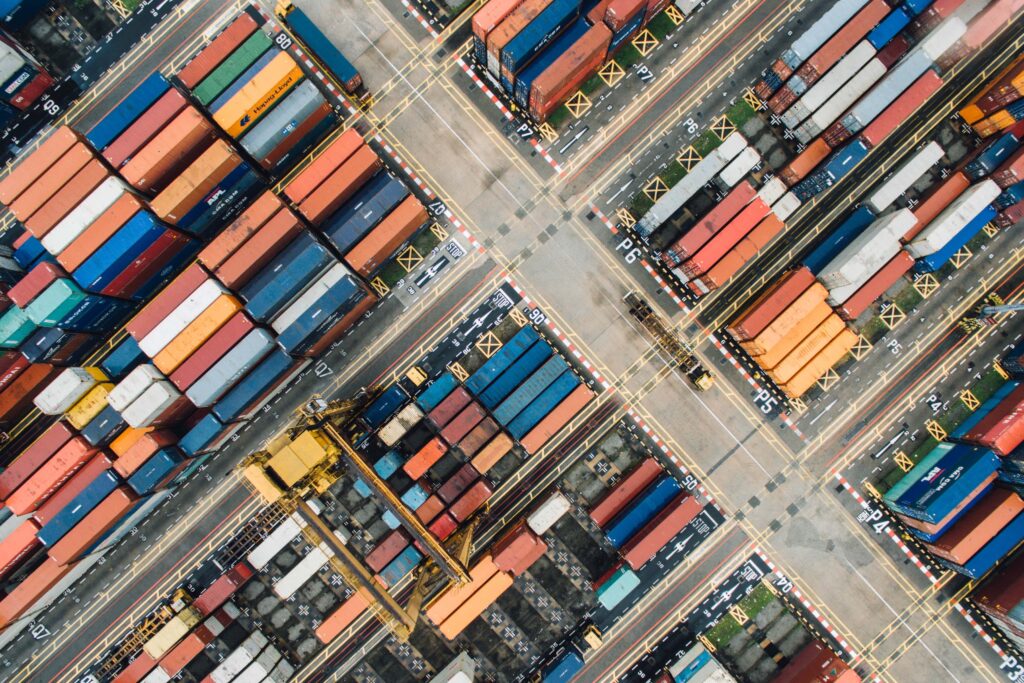 An aerial view of shipping containers in stacks.