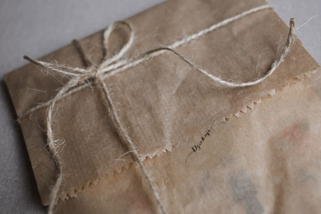 A nicely tied bow of twine around a paper-wrapped parcel.