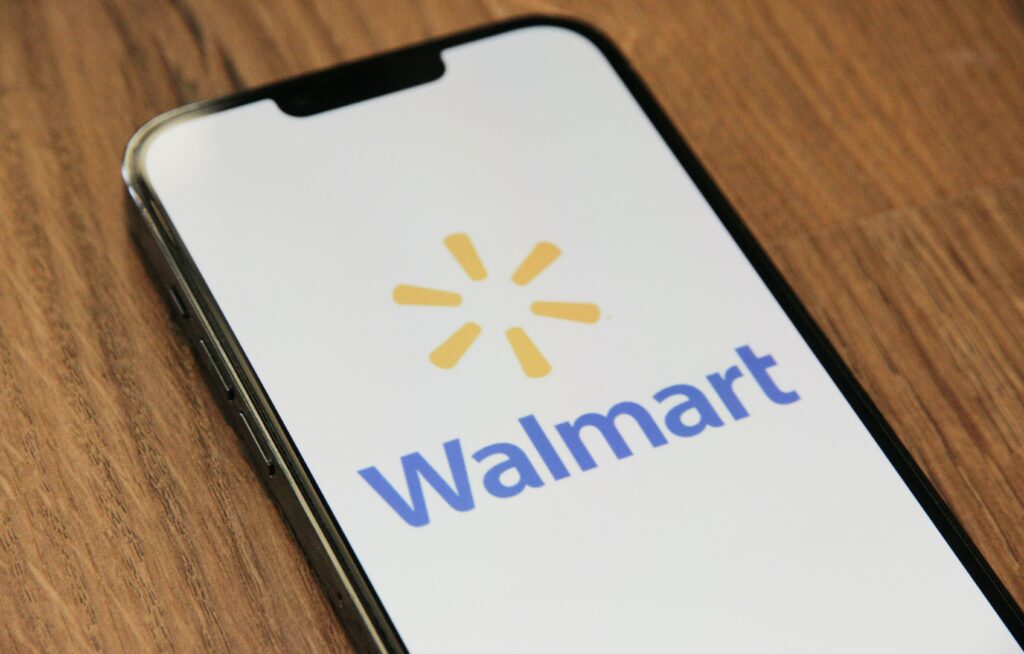 Walmart logo is pictured on a smartphone.