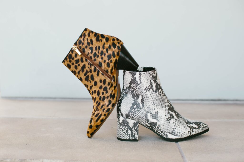 Leopard print and snake skin heals are playfully positioned on the floor.