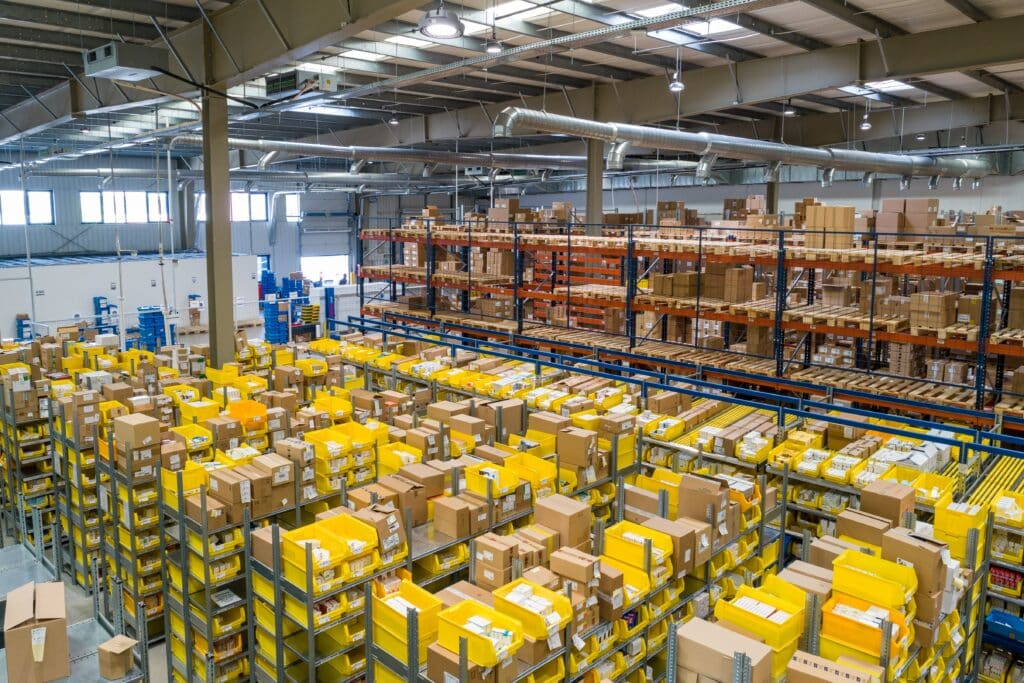 A large interior of a warehouse. Taken from up high.