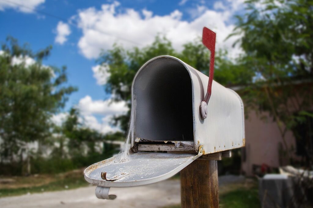 An empty mailbox with cobwebs.