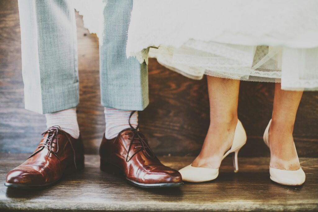 A man and a woman's feet as they stand side by side.