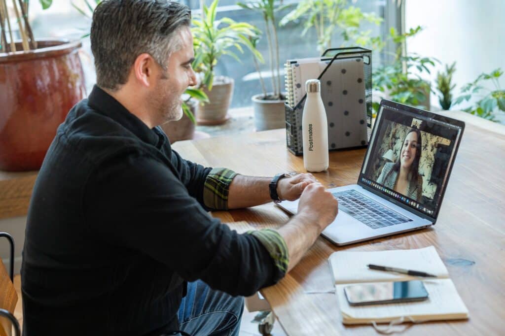 Someone is getting USPS Form 1583 Online Notary over a video call from a laptop.