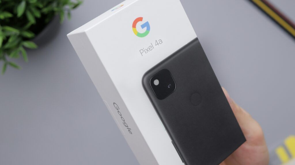 A Google Pixel A4 in the box is being handled as someone is researching if there are tips for shipping electronics.