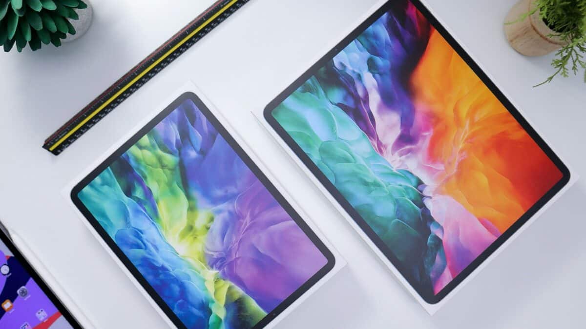 Apple iPads arranged on a table for inspection before shipping electronics.