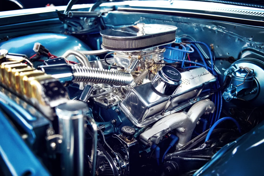 A close up photo of the engine of a classic car.