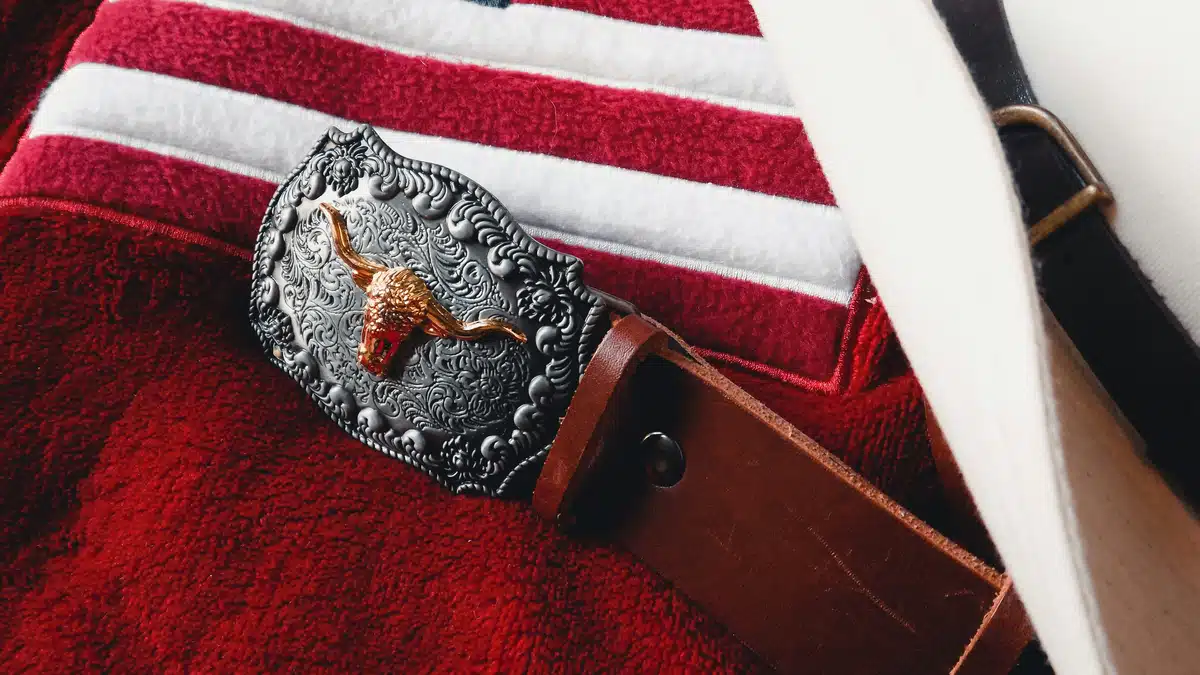A cowboy belt lays across an American flag, representing the patriotism in PostFromUS Texas Forwarding Services.