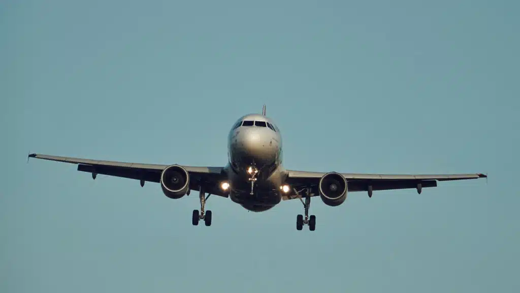 The front view of a flying plane shipping to Hawaii from Mainland USA.